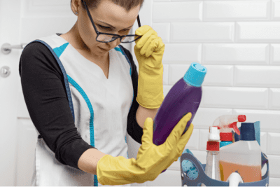 Move Out Clean, Woman Looking at Cleaning Bottle